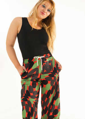 The Wicked Torque Pant | A Comfy Piece for a Twisted Vibe | Wide Legged Snap Off Sweatpants with Black Red and Green Print | Goose Taffy